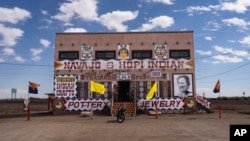 FILE - Navajo and Hopi arts and crafts are promoted on the facade of a storefront in Winslow, Arizona, Oct. 15, 2024.