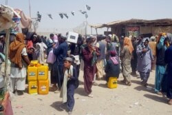 People arriving from Afghanistan gather after they cross into Pakistan at the Friendship Gate crossing point, in the Pakistan-Afghanistan border town of Chaman, Pakistan, Sept. 6, 2021.