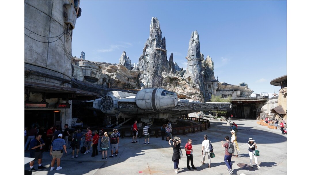 Park visitors walk near the entrance to the Millennium Falcon Smugglers Run ride during a preview of the Star Wars themed land, Galaxy's Edge in Hollywood Studios at Disney World, Aug. 27, 2019, in Lake Buena Vista, Florida.