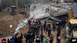 FILE - Palestinians search for survivors after an Israeli airstrike in Deir al Balah, Gaza Strip, February, 2024.