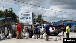 Kliyan ki mete yo an liyn pou yo achte gaz pwopàn nan magazen Socastee Hardware, nan vil Myrtle Beach, nan Kawolin di Sid, anvan Siklòn Florence rive sou rejyon an. (Foto: 10 septanm 2018).