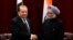 FILE - Pakistan's Prime Minister Nawaz Sharif (L) shakes hands with India's Prime Minister Manmohan Singh during the United Nations General Assembly in New York.