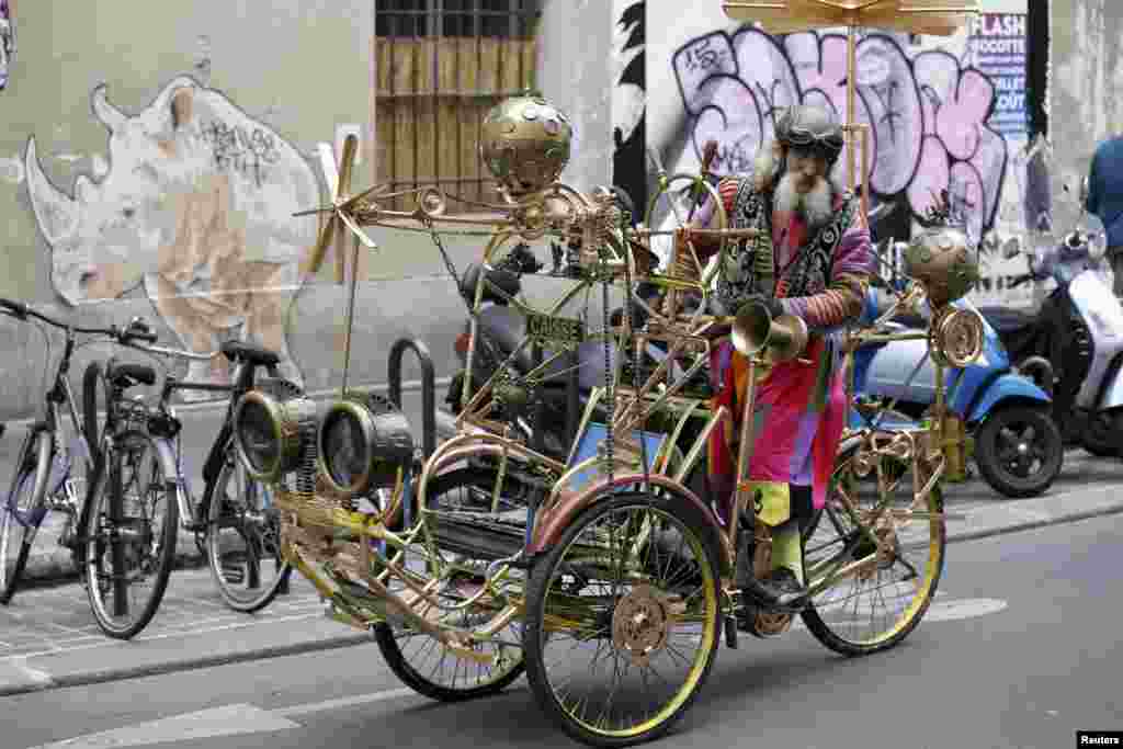 French artist Gino rides the &quot;Celestial Cyclo&quot; tricycle built by him in Le Marais neighborhood in Paris, Aug. 15, 2015.