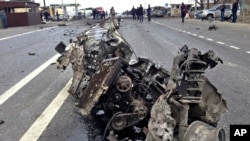 The wreckage of a suicide bomber's car is seen near a traffic police check point near Derbent in Russia's northern Caucasus region of Dagestan on Monday, Feb. 15, 2016.