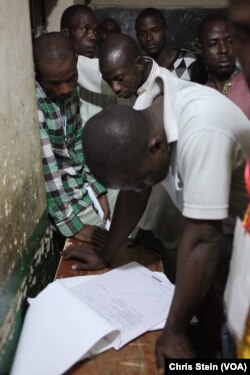 People gather to review results at a polling station in Kawaji Ward in Kano, Nigeria, March 28, 2015.