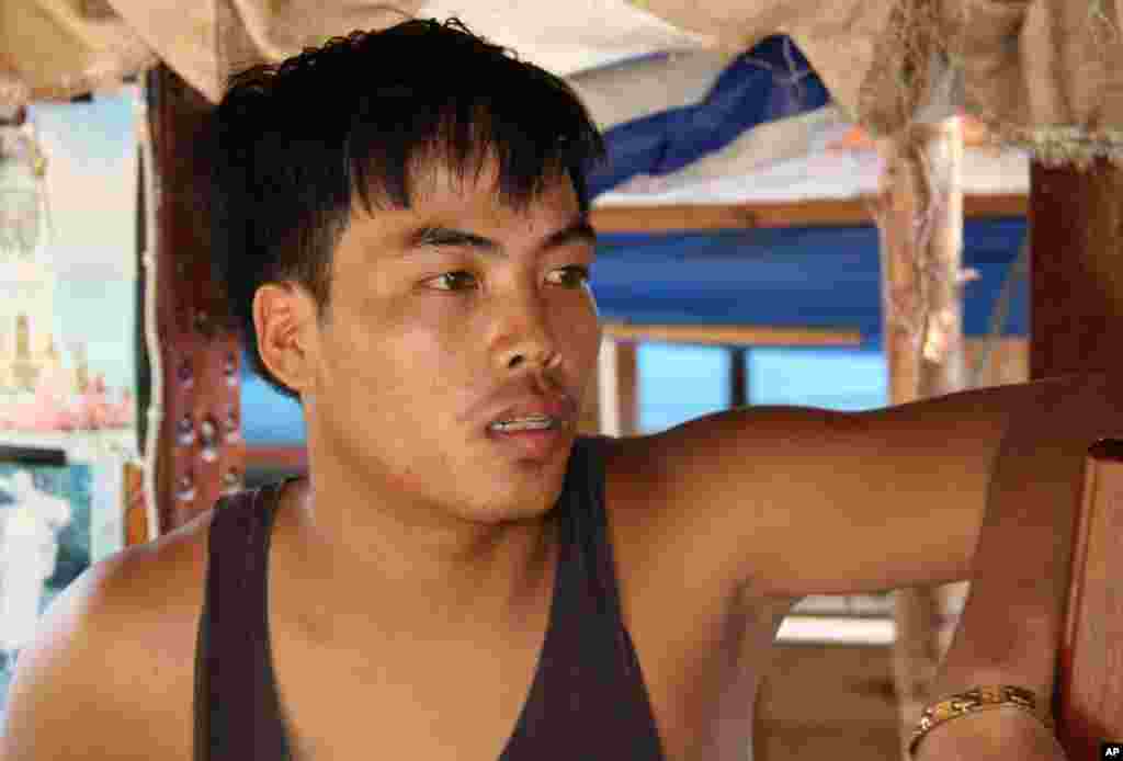 A Lao boatman, Porn, was robbed by pirates in March on the way to China. (VOA - D. Schearf)