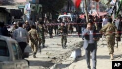 Security forces inspect the site of a suicide attack outside a Shiite mosque in Kabul, Afghanistan, Sept. 29, 2017. 