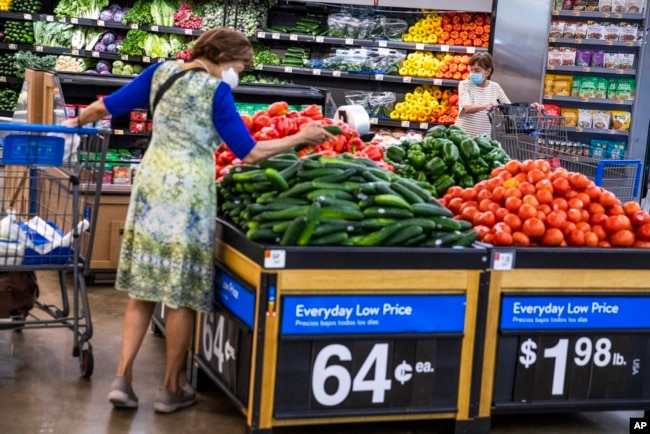 FILE - People buy groceries at a Walmart Superstore in Secaucus, N.J., July 11, 2024.