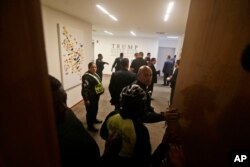 A group of Panamanian police officers stand inside the Trump Ocean Club International Hotel and Tower in Panama City, March 5, 2018.
