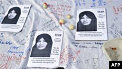 A boy signs a petition calling for an end to stoning during a demonstration by members of the International Committee Against Stoning in Trafalgar Square, London, 24 Jul 2010