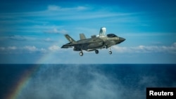 A U.S. Marines F-35B Lightning II fighter aircraft prepares to land on the flight deck of the U.S. Navy amphibious assault ship USS America during flight operations in the South China Sea April 18, 2020. Picture taken April 18, 2020. 