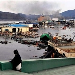 A warehouse and vehicles are washed away in Kesennuma
