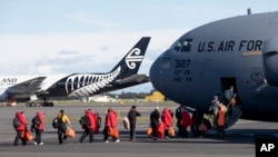 Staff board a U.S. Air Force C-17 as they prepare to take the season's first flight to McMurdo Station in Antarctica from Christchurch Airport, New Zealand, Monday, Sept. 14, 2020. (AP Photo/Mark Baker)