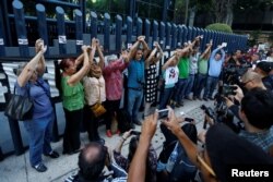 Activists and journalists protest outside the attorney general's office following a report that their smartphones had been infected with spying software sold to the government to fight criminals and terrorists in Mexico City, Mexico, June 23, 2017.