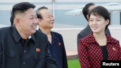 North Korean leader Kim Jong Un (2nd L) and a woman being identified by state TV as his wife 'Comrade Ri Sol Chu,' visit the Rungna People's Pleasure Ground, which is nearing completion, in Pyongyang, July 25, 2012.