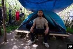 FILE - Chen Wang, a Chinese migrant currently homeless in New York, is pictured in front of his tent, May 3, 2024. Chen came to the U.S. after being admonished by Chinese police for anti-Chinese Communist Party posts on X.