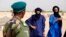 A Malian soldier speaks with Tuareg men Seydou (C) and Abdoul Hassan in the village of Tashek, outside Timbuktu, July 27, 2013. 