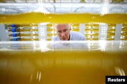 Svein Nordvik, managing director of Norwegian startup CO2Bio, inspects algae growing in transparent tubes at a greenhouse in Mongstad, Norway, July 31, 2018.
