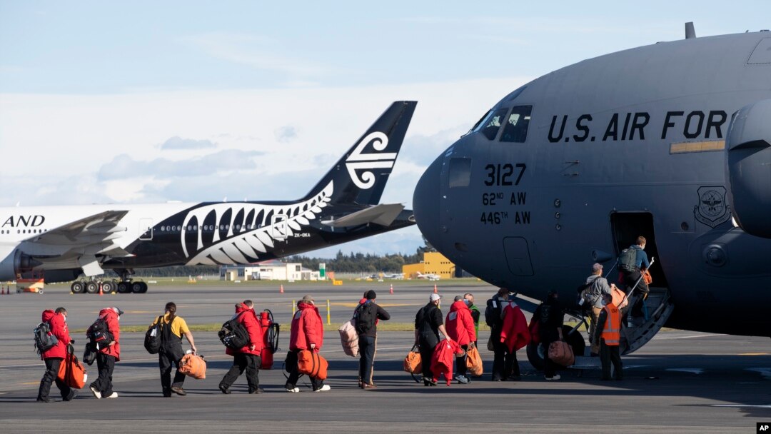 Staff board a U.S. Air Force C-17 as they prepare to take the season's first flight to McMurdo Station in Antarctica from Christchurch Airport, New Zealand, Monday, Sept. 14, 2020. (AP Photo/Mark Baker)