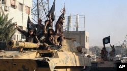 FILE- Islamic States fighters hold a parade in Raqqa, Syria. 