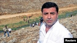 Co-chairman of the pro-Kurdish Peoples' Democratic Party, Selahattin Demirtas walks with his party members to the southeastern town of Cizre, near Idil in Sirnak province, Turkey, Sept. 10, 2015.