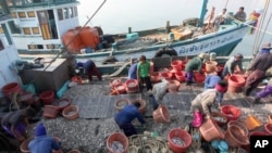 Myanmar workers work on fishing boats at a pier in Prachuabkhirikhant province, southern Thailand, file photo. 