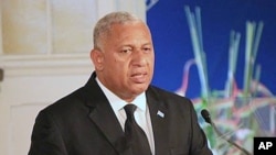 FILE - Fiji Prime Minister Frank Bainimarama, pictured speaking in Suva, Sept. 6, 2013, says "cities in the developed world like Miami, New York, Venice or Rotterdam" are as vulnerable to rising seas as tropical islands.