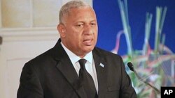 FILE- Fiji's Prime Minister Frank Bainimarama comments on how the country's constitution enshrines principles including an independent judiciary, a secular state, and a range of civil, political, and socio-economic rights, during a speech in Suva, Sept. 6, 2013.
