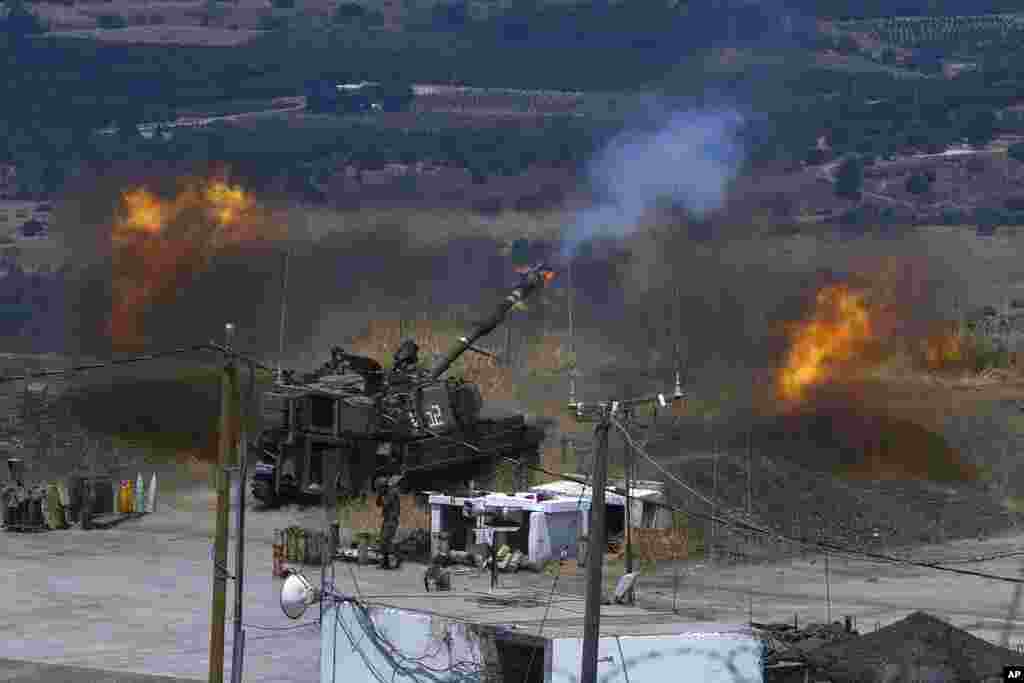 Israeli forces fire artillery from their position on the border with Lebanon after a barrage of rockets were fired from Lebanon.