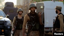 FILE - Soldiers return to the staging area after participating in a security operation on the outskirts of Peshawar, Pakistan June 24, 2017. Raza Rabbani, the chairman of the Pakistani Senate, upper house of parliament, denounces what he called U.S. President Donald Trump's policy of blaming Pakistan for failures of the United States in Afghanistan. 