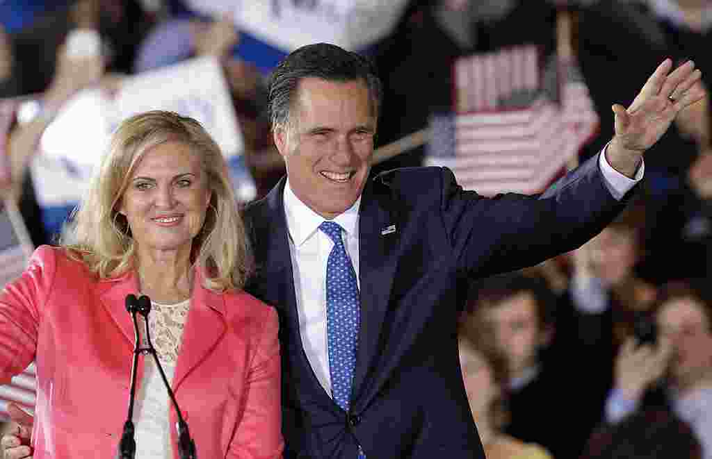 Republican presidential candidate, former Massachusetts Gov. Mitt Romney and his wife Ann wave to supporters at his Super Tuesday campaign rally in Boston, Tuesday night, March 6, 2012. (AP Photo/Stephan Savoia)
