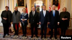 From L-R, defense ministers from Australia, Germany, France, the U.S., Britain, and the Netherlands pose for a photo at the Defense Ministry in Paris, France, Jan. 20, 2016.