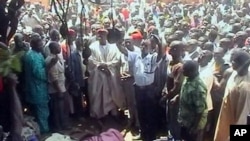 In this image taken from TV showing the bodies of victims of inter-faith violence as a crowd gathers around, in the town of Dogo Nahawa, Nigeria, south of the city of Jos (File Photo)