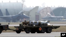 FILE - A weapon is carried by a truck at the Aviano NATO air base, in Aviano, Italy, March 25, 2011. A set of 80 cards on an online flashcard site detailed hot and cold vaults at the air base, according to a report May 28, 2021.