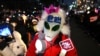 A man wearing a mask with the word "Impeachment" written on it waves light sticks as he takes part in a protest calling for the ouster of South Korea President Yoon Suk Yeol, near the National Assembly in Seoul on Dec. 13, 2024.