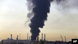 A plume of smoke rises up from a main oil refinery south of Tehran, Iran, June 3, 2021. 