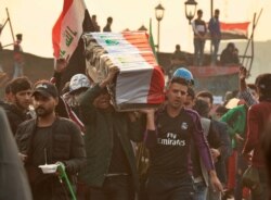 Anti-government protesters carry a symbolic coffin during protests in Baghdad, Nov. 29, 2019. Hundreds of protesters have died since Oct. 1, when thousands of Iraqis took to the streets to decry corruption, poor services and lack of jobs.