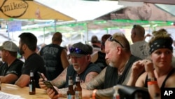 People congregate at One-Eyed Jack's Saloon during the 80th annual Sturgis Motorcycle Rally on Aug. 7, 2020, in Sturgis, South Dakota. 