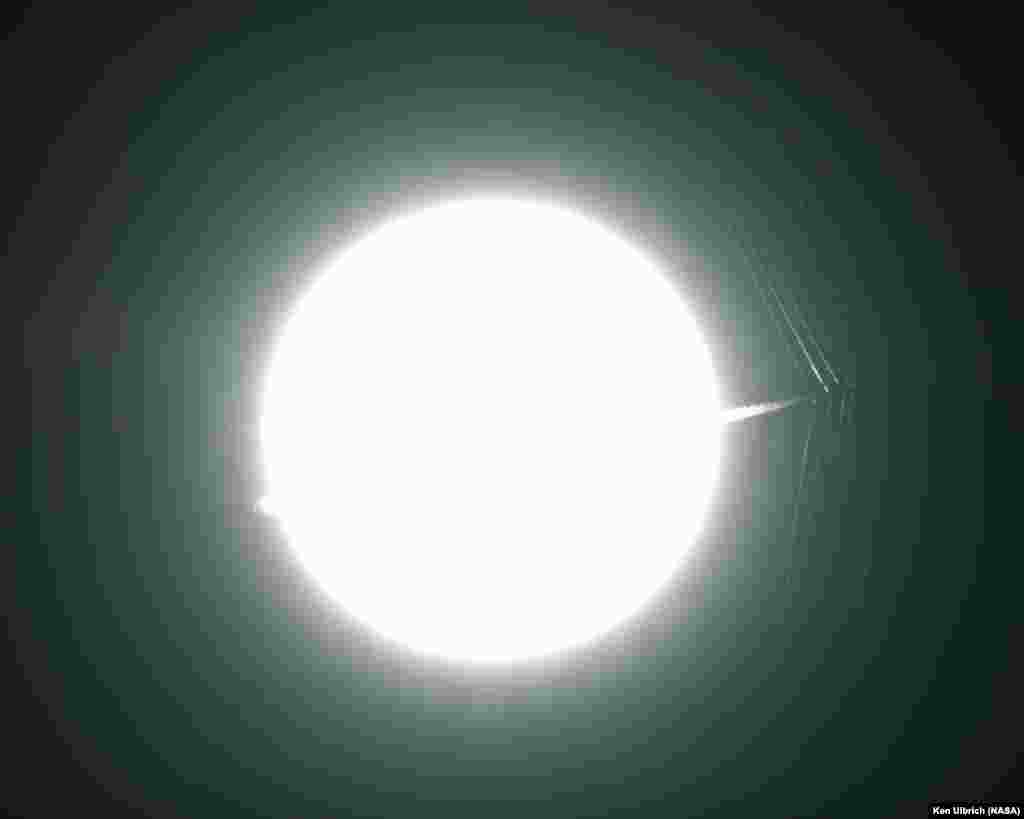 An Air Force Test Pilot School T-38C passes in front of the sun at a supersonic speed, creating shockwaves that are caught photographically for research. NASA is using a modern version of schlieren imagery to visualize supersonic flow phenomena with full-scale aircraft in flight. The results will help engineers design a quiet supersonic transport.