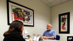 Kim Mueller, left, administers a test to Alan Sweet, in which he describes an illustration, as part of a University of Wisconsin-Madison study on dementia, July 6, 2017. The study found that for some people subtle changes in everyday speech can be correlated with early mild cognitive impairment, which can be a precursor to Alzheimer's disease. 