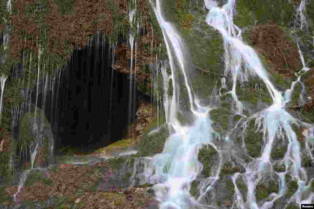 A waterfall is pictured outside the Grotte aux Fees (Fairy Cave), where since 1864, visitors can see an underground river come out in the rocks 500 meters inside the mountain, in St-Maurice, Switzerland.