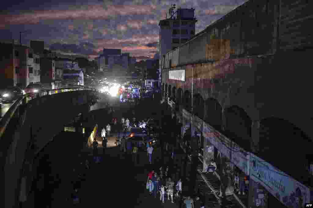 People are seen in the streets of Petare neighborhood after Caracas and other parts of Venezuela were hit by a massive power cut on July 22, 2019.