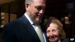 FILE - Fidel Castro Diaz-Balart, son of Cuba's former President Fidel Castro and senior researcher and professor of the Cuban Academy of Sciences meets his mother, Mirta Diaz-Balart, during the opening session of a scientific seminar in Havana, Nov. 14, 2008.