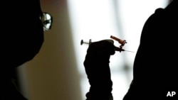 FILE - In this April 26, 2021, photo, a nursing student administers the Moderna COVID-19 vaccine at a vaccination center at UNLV, in Las Vegas. 