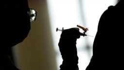 FILE - In this April 26, 2021, photo, a nursing student administers the Moderna COVID-19 vaccine at a vaccination center at UNLV, in Las Vegas. 
