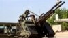 A Libyan fighter loyal to the Government of National Accord (GNA) mans a turret mounted on the back of a pickup truck during clashes with forces loyal to strongman Khalifa Haftar south of the capital Tripoli's suburb of Ain Zara, April 10, 2019. 