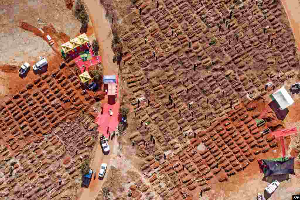 This aerial picture shows several funerals being held at the Olifantsvlei Cemetery in Soweto, South Africa, July 25, 2020.