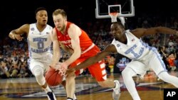 Syracuse's Trevor Cooney (10) drives against North Carolina's Nate Britt (0) and Theo Pinson (1) during the first half of the NCAA Final Four tournament college basketball semifinal game Saturday, April 2, 2016, in Houston. (AP Photo/David J. Phillip)