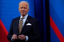 President Joe Biden stands on stage during a break in a televised town hall event at Pabst Theater, Feb. 16, 2021, in Milwaukee.