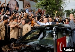 Turkish President Tayyip Erdogan waves to supporters as he leaves his residence in Istanbul, Turkey, June 24, 2018.